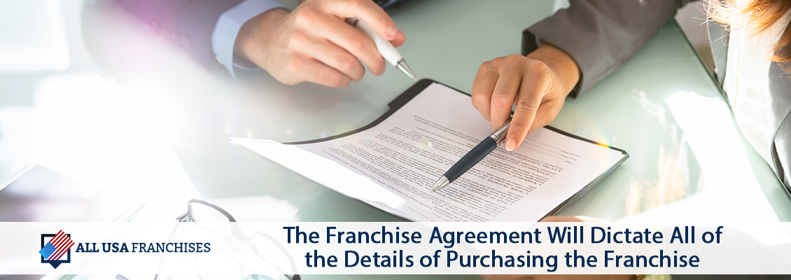 Lawyer Holding Pen Reviewing Franchise Agree Document Which Dictates All the Details of Purchasing the Franchise