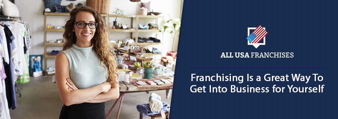 Female Franchisee Standing in Her Clothing Boutique Smiling Because She Got Into Business for Herself