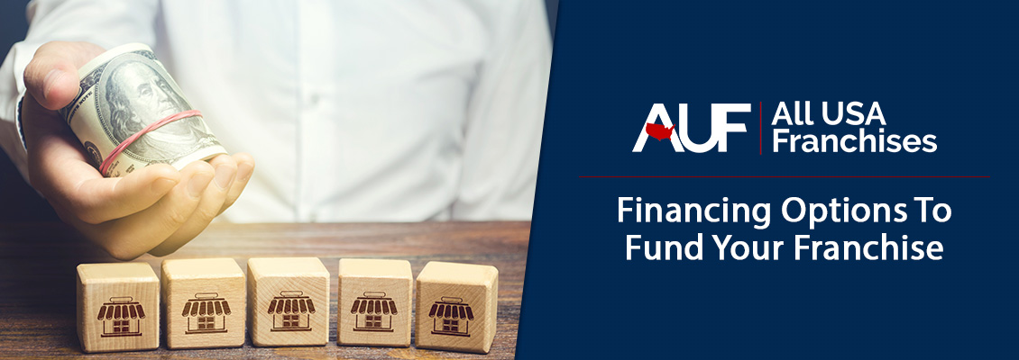 Person Holding Cash To Fund Their Franchise in Front of Five Wooden Blocks Symbolizing Business Growth