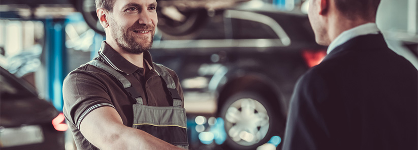 Man Attending a Customer in an Automotive Franchise