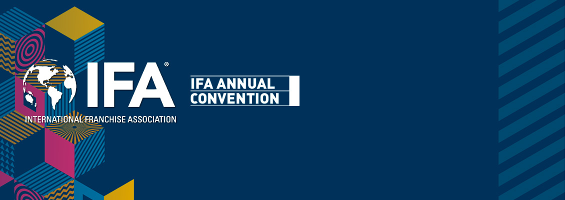The International Franchise Association Logo With a Background of Colored Cubes